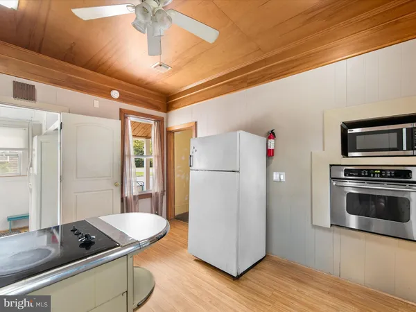 a kitchen with granite countertop a stove and a refrigerator