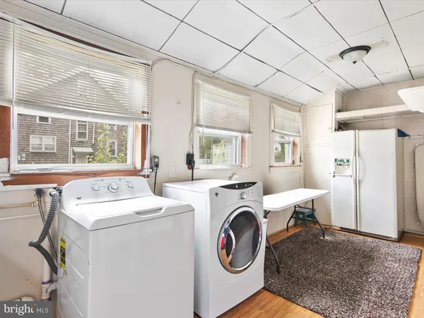 a utility room with dryer washer and a window