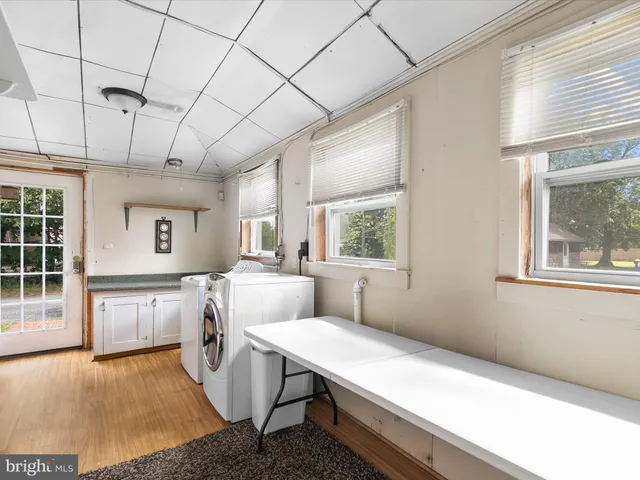 a living room with stainless steel appliances kitchen island granite countertop furniture and a window