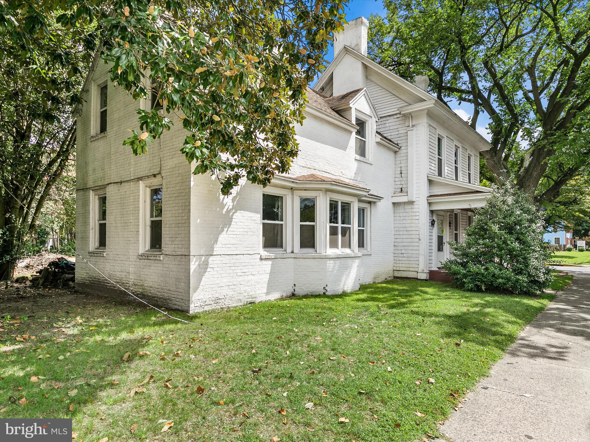 202 North Bedford Street Georgetown, DE 19947 - Photo 17 of 22 a front view of a house with a garden