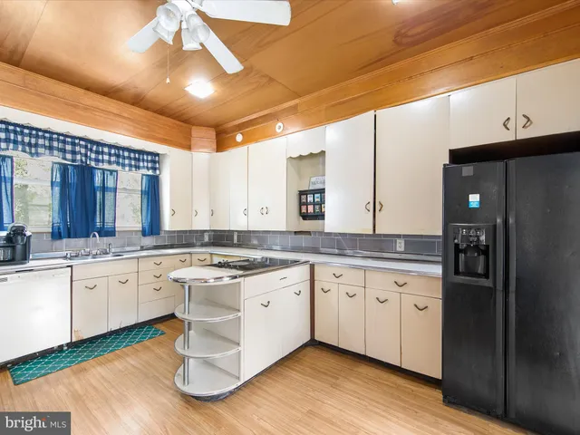 a large kitchen with cabinets and stainless steel appliances