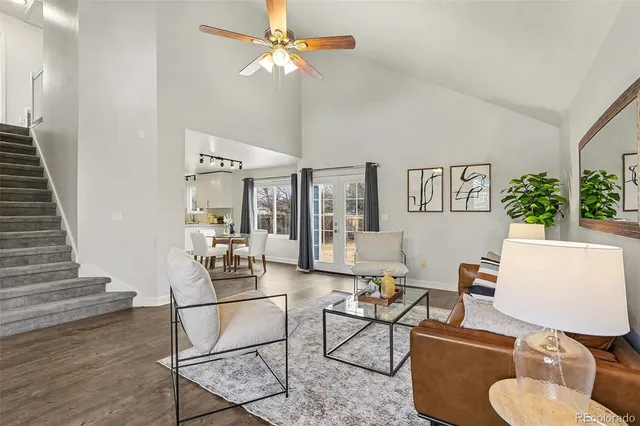 a living room with furniture and wooden floor