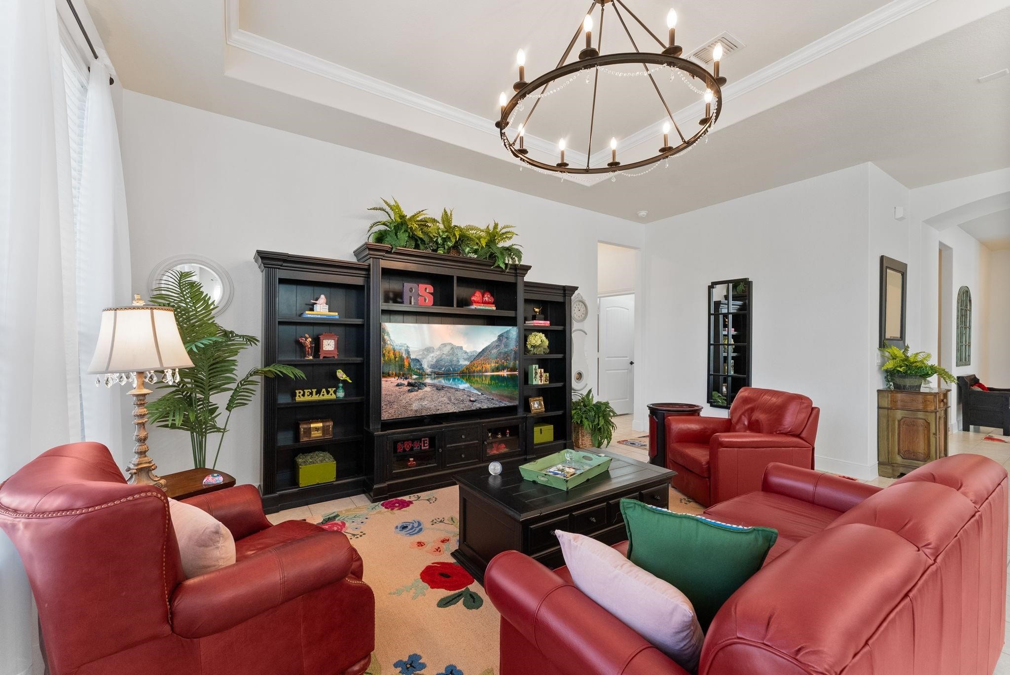 230 Galloway Court Spring, TX 77382 - Photo 11 of 32 a living room with furniture a dining table and a chandelier