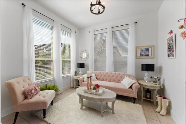 a living room with furniture flowerpot and wooden floor