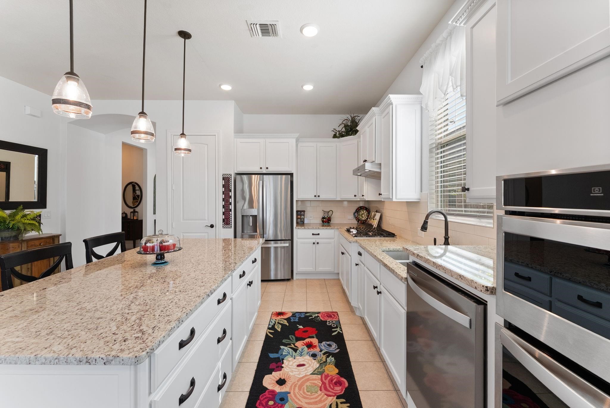 230 Galloway Court Spring, TX 77382 - Photo 17 of 32 a large kitchen with granite countertop a sink a counter space appliances and cabinets