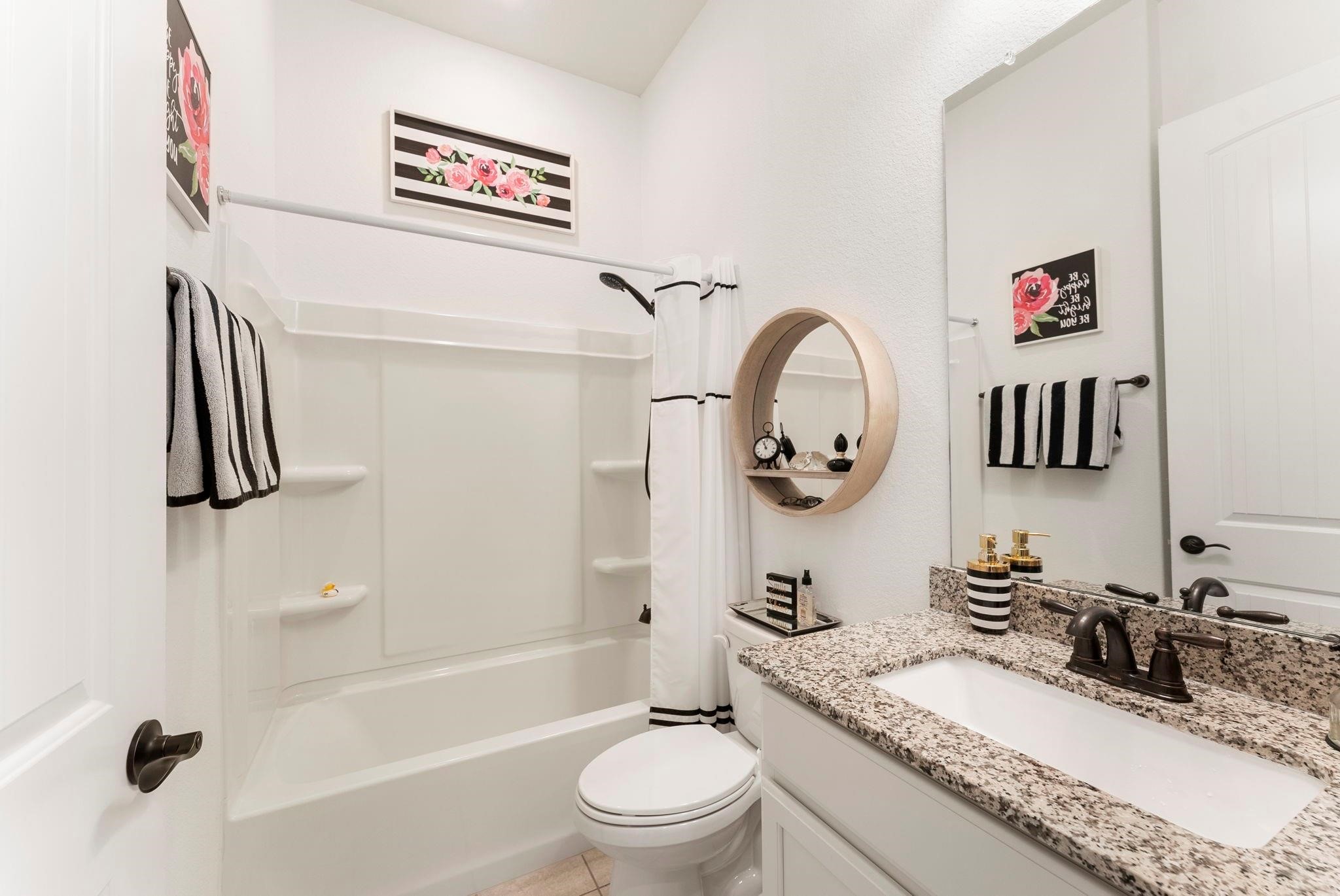 230 Galloway Court Spring, TX 77382 - Photo 23 of 32 a bathroom with a granite countertop sink mirror vanity and toilet
