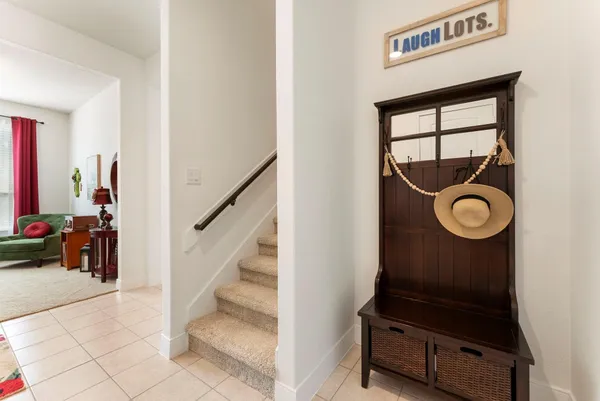 a living room with furniture a rug and a wall painting