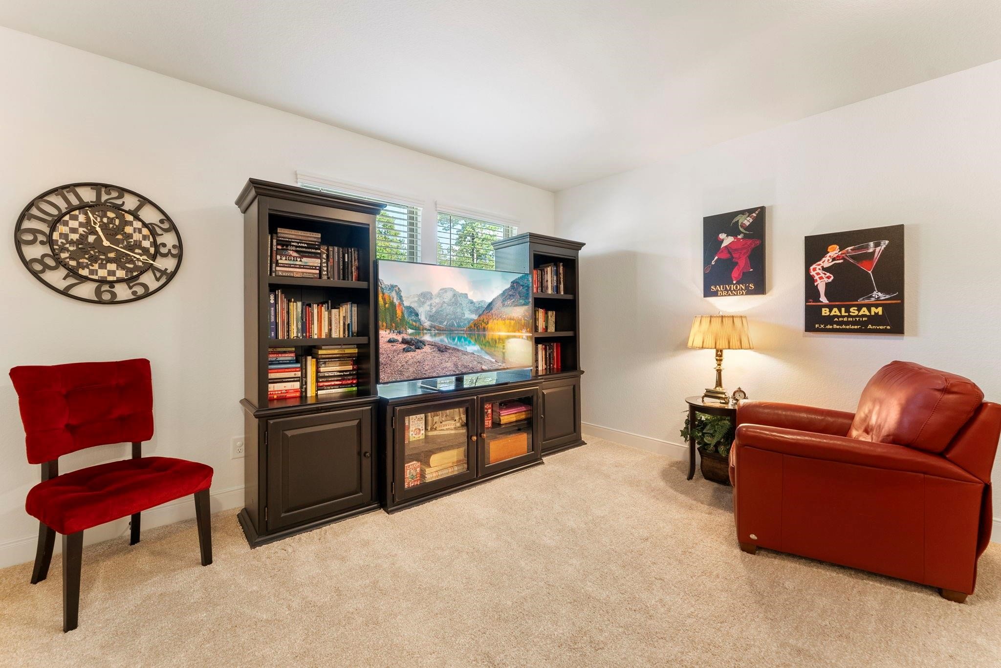 230 Galloway Court Spring, TX 77382 - Photo 25 of 32 a living room with furniture a rug and a wall painting
