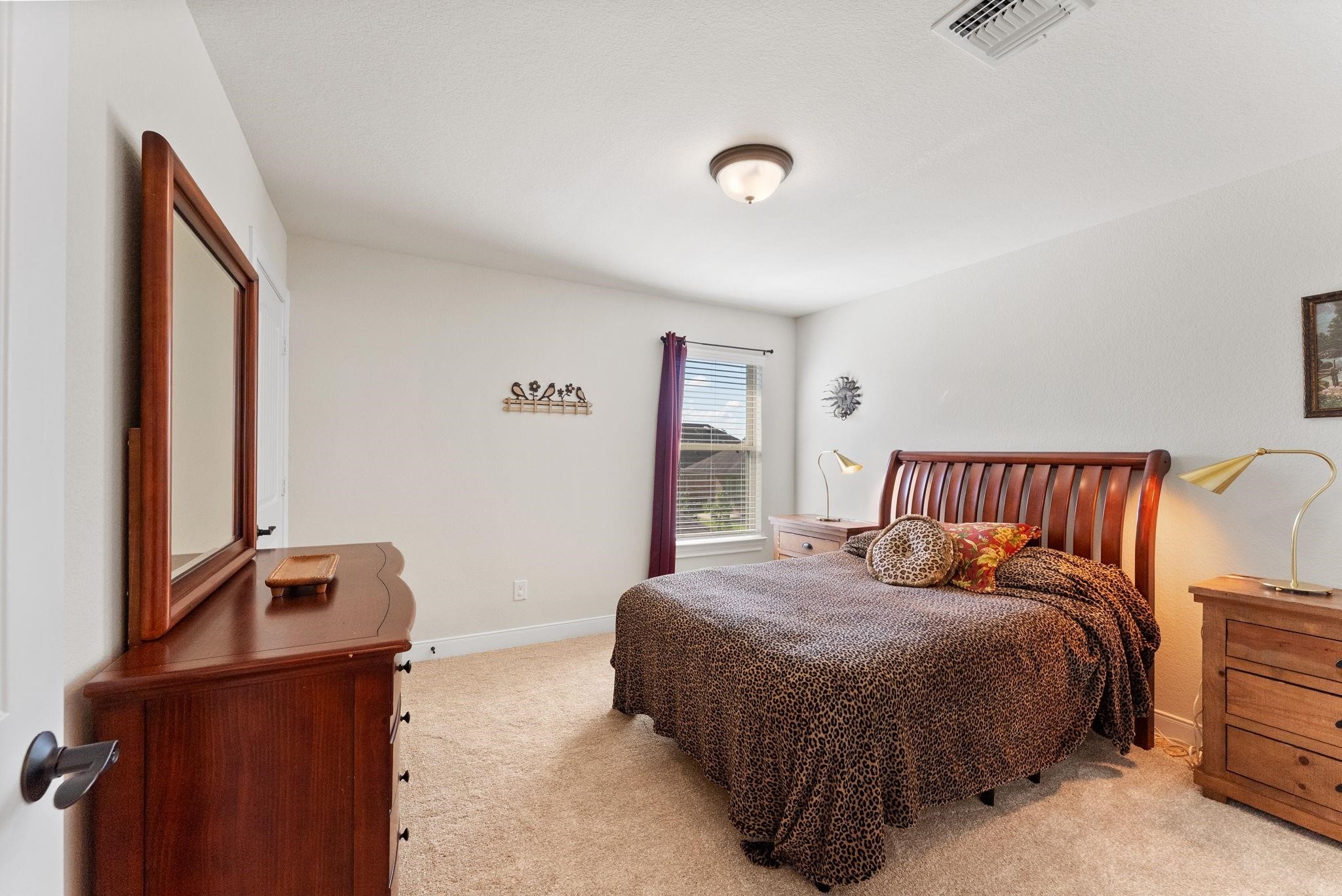 230 Galloway Court Spring, TX 77382 - Photo 28 of 32 a bedroom with a bed and dresser