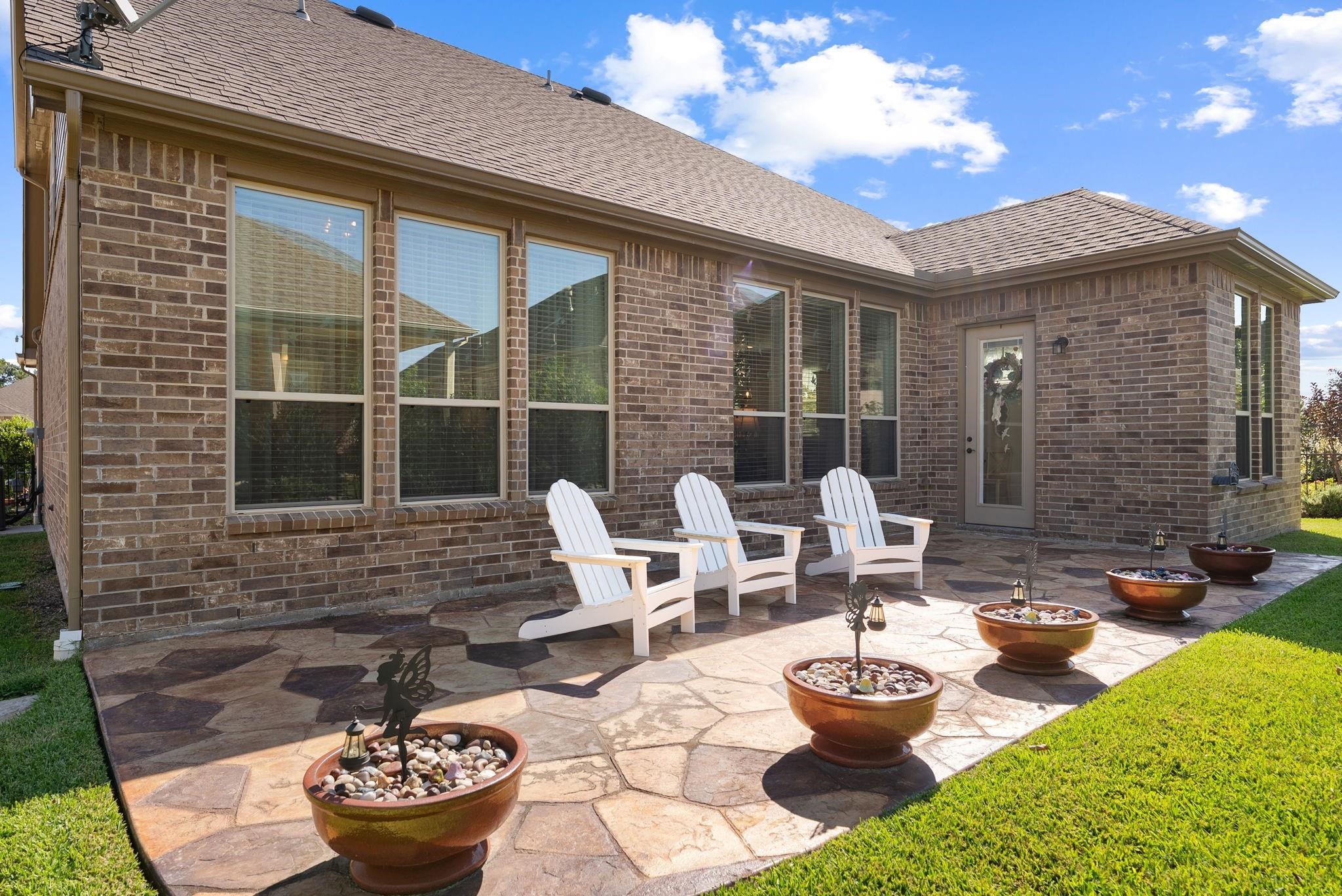 230 Galloway Court Spring, TX 77382 - Photo 32 of 32 a front view of a house with patio chairs and a potted plant
