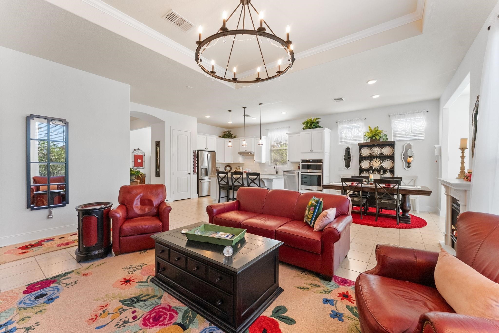 230 Galloway Court Spring, TX 77382 - Photo 9 of 32 a living room with furniture a rug kitchen view and a chandelier