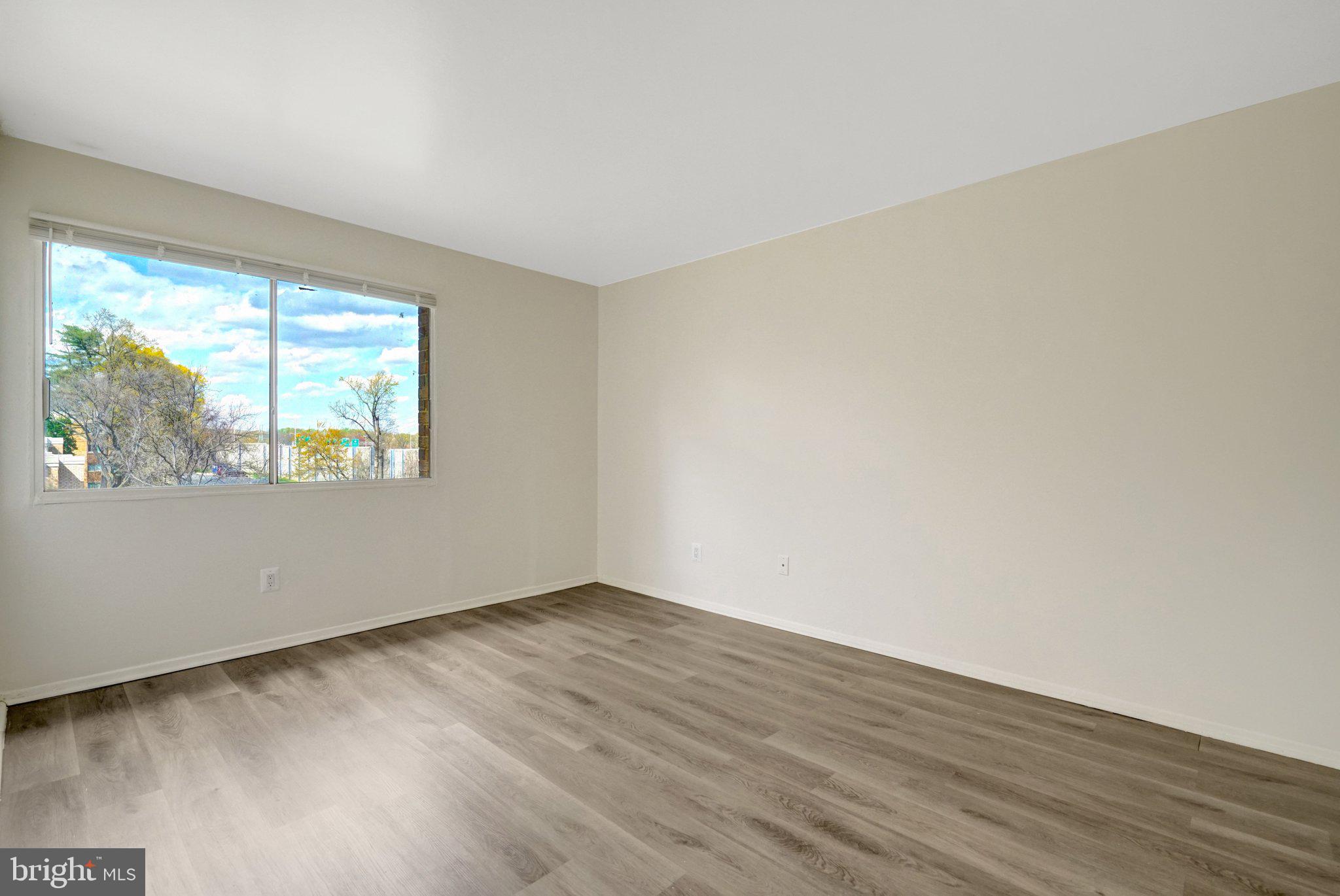 2904 Kings Chapel Road, Unit 5/16 Falls Church, VA 22042 - Photo 19 of 30 a view of an empty room with wooden floor and a window