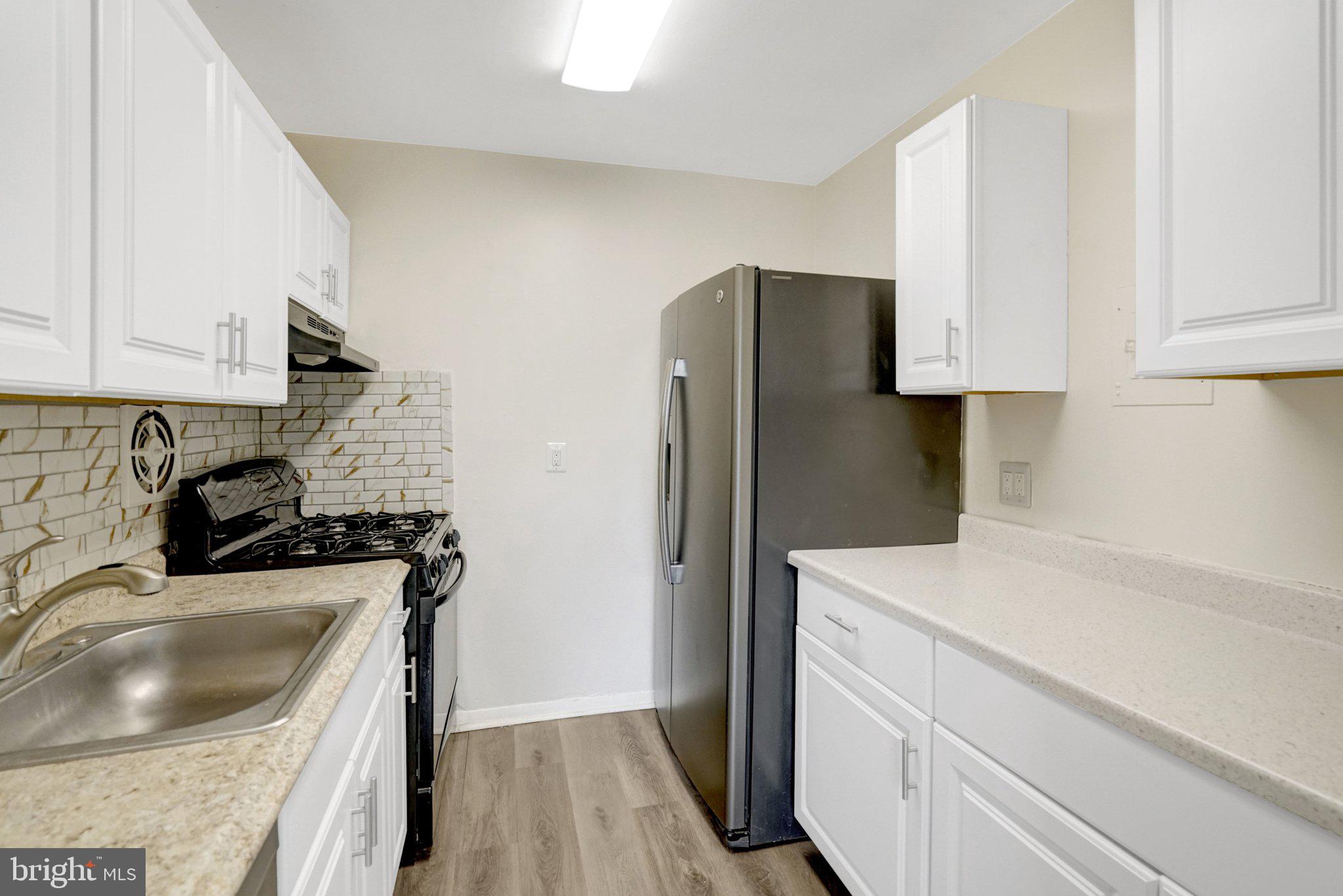 2904 Kings Chapel Road, Unit 5/16 Falls Church, VA 22042 - Photo 4 of 30 a kitchen with a refrigerator sink and stove