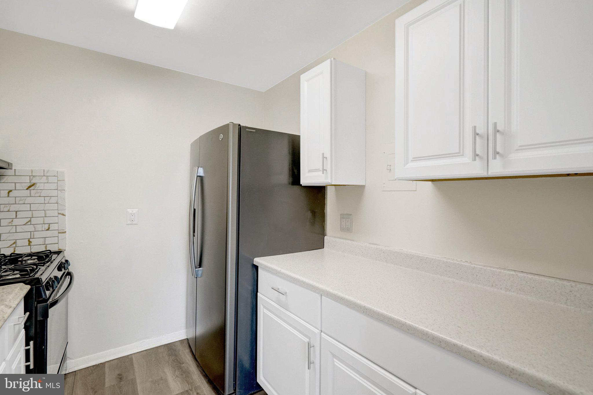 2904 Kings Chapel Road, Unit 5/16 Falls Church, VA 22042 - Photo 5 of 30 a kitchen with stainless steel appliances white cabinets and a refrigerator