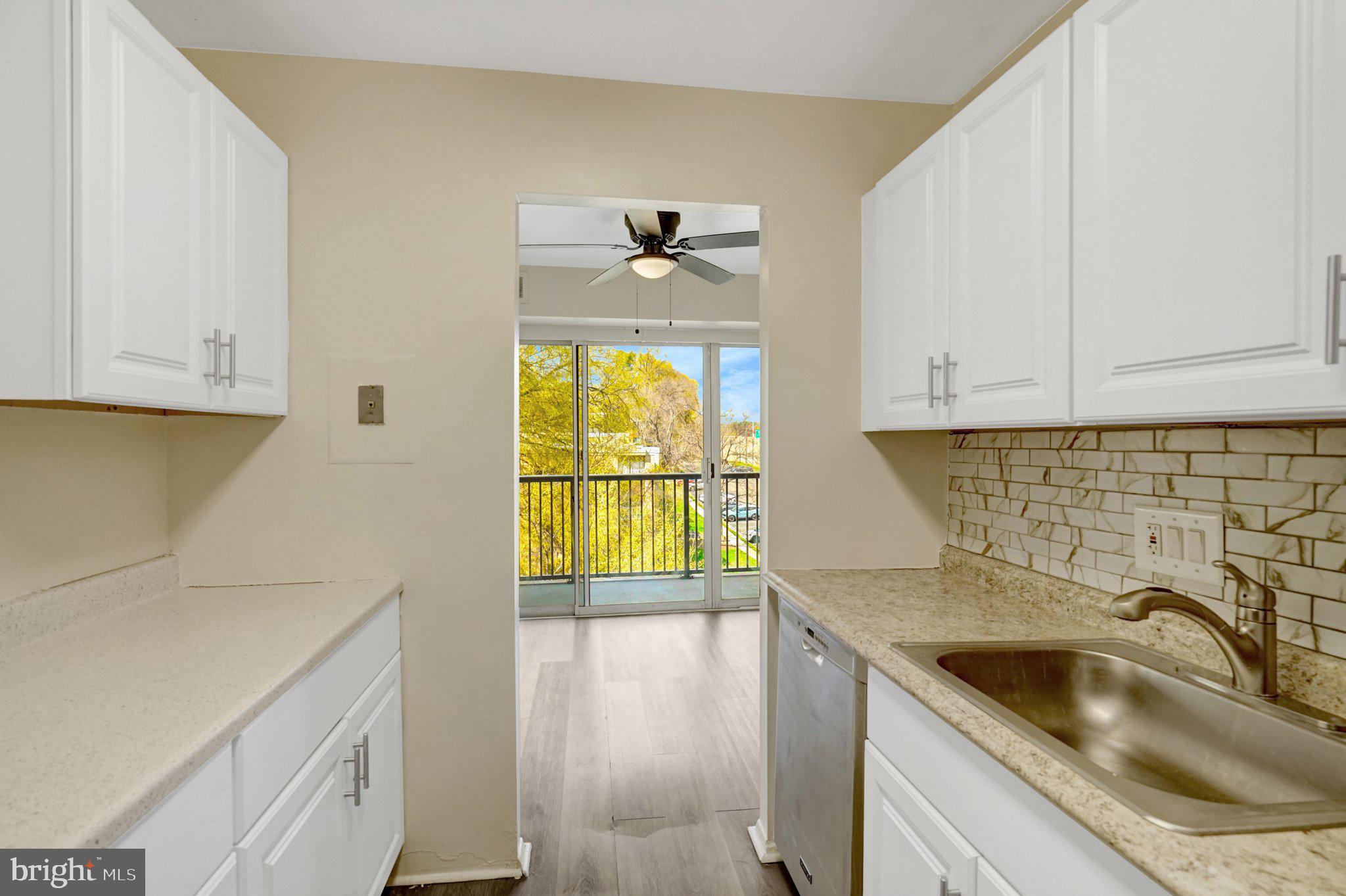 2904 Kings Chapel Road, Unit 5/16 Falls Church, VA 22042 - Photo 7 of 30 a kitchen with a sink and a stove with wooden floor