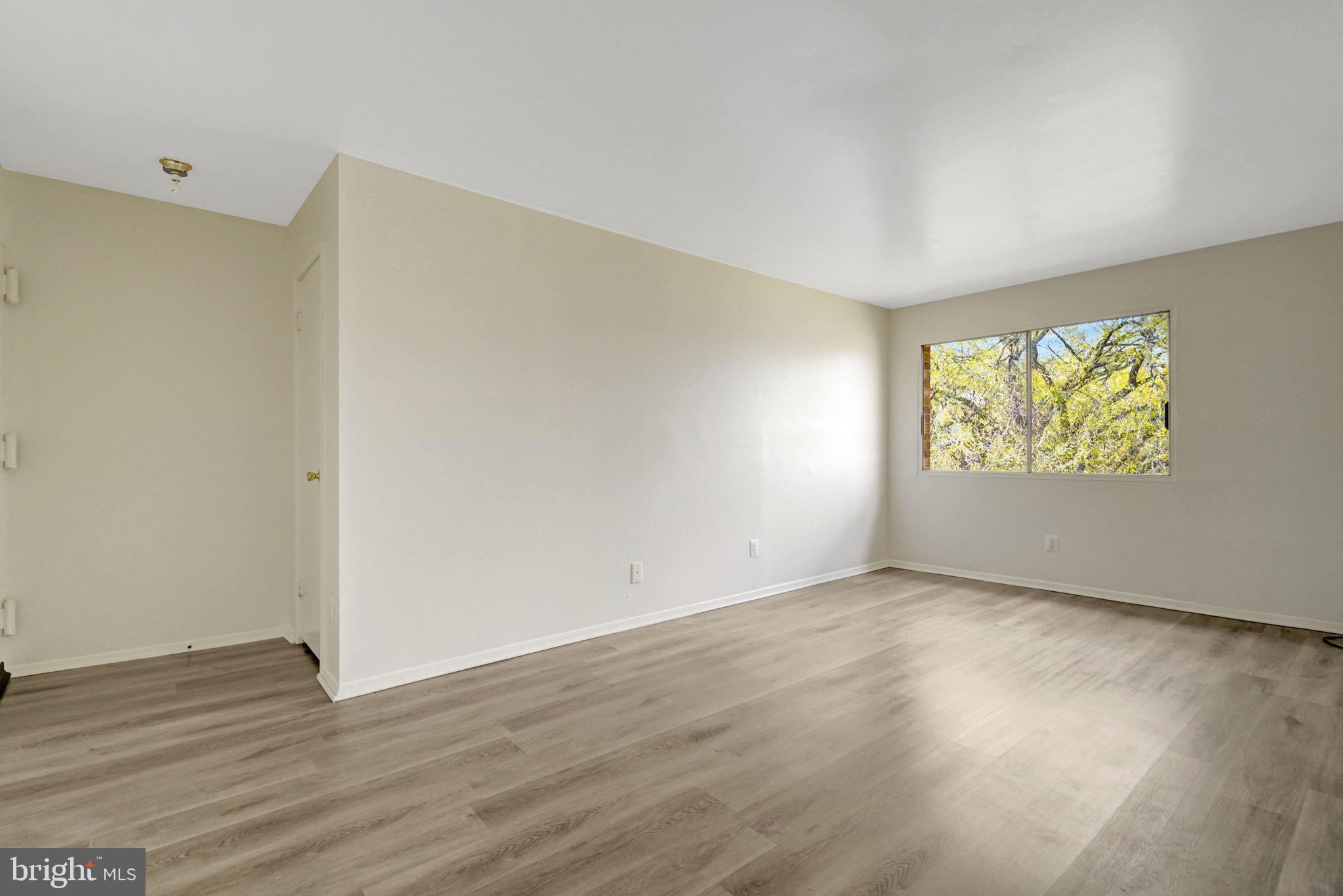 2904 Kings Chapel Road, Unit 5/16 Falls Church, VA 22042 - Photo 8 of 30 a view of an empty room with wooden floor and a window