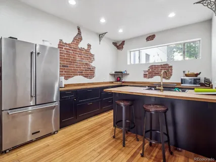 a kitchen with granite countertop a sink appliances and cabinets