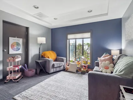 a living room with furniture chess table and a lamp