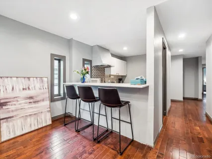 a kitchen with kitchen island a counter top space a sink stainless steel appliances and cabinets