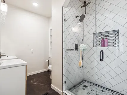 a bathroom with a shower and mirror