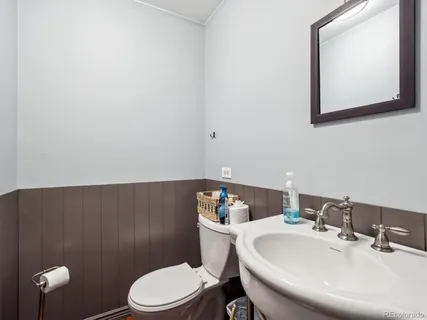 a bathroom with a sink a toilet and mirror