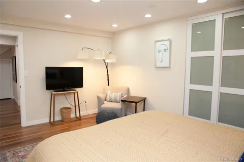 a kitchen with stainless steel appliances granite countertop a refrigerator and a dining table