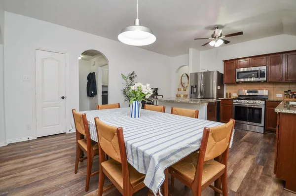 a view of a dining room with furniture and wooden floor