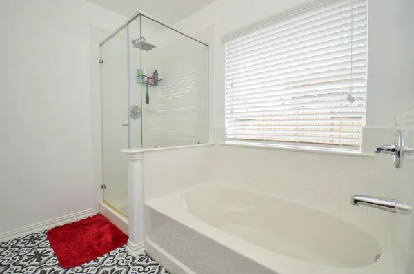 a bathroom with a bathtub and a shower