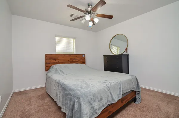 a bedroom with a bed and window