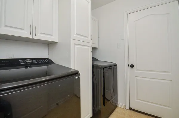 a kitchen with granite countertop white cabinets and a refrigerator