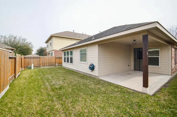 a backyard of a house with table and chairs