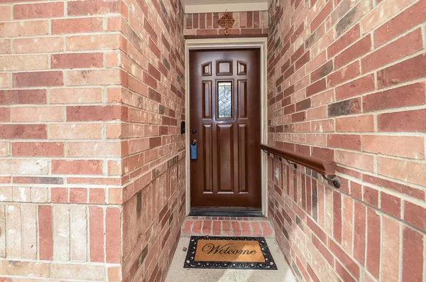 a view of a brick house with a door and a window