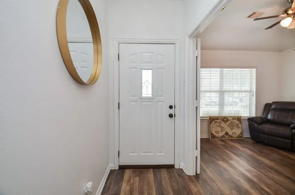 a view of a livingroom with furniture and mirror