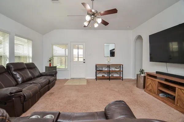 a living room with furniture and a flat screen tv