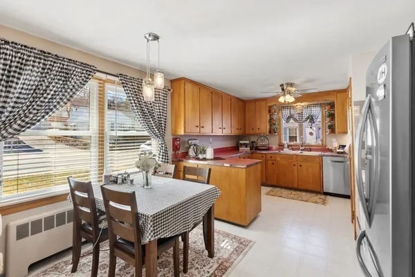 a kitchen with stainless steel appliances granite countertop a sink dishwasher stove refrigerator and cabinets