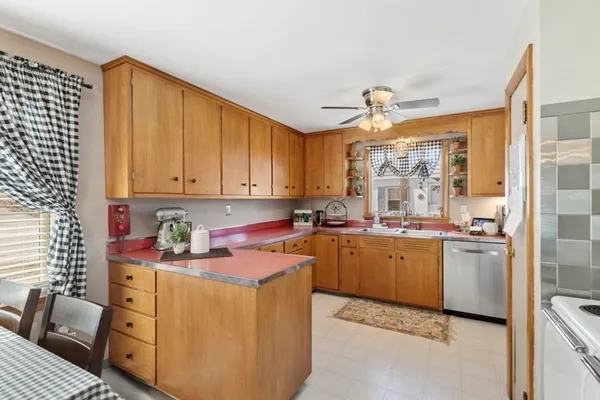 a kitchen with a refrigerator and a stove top oven