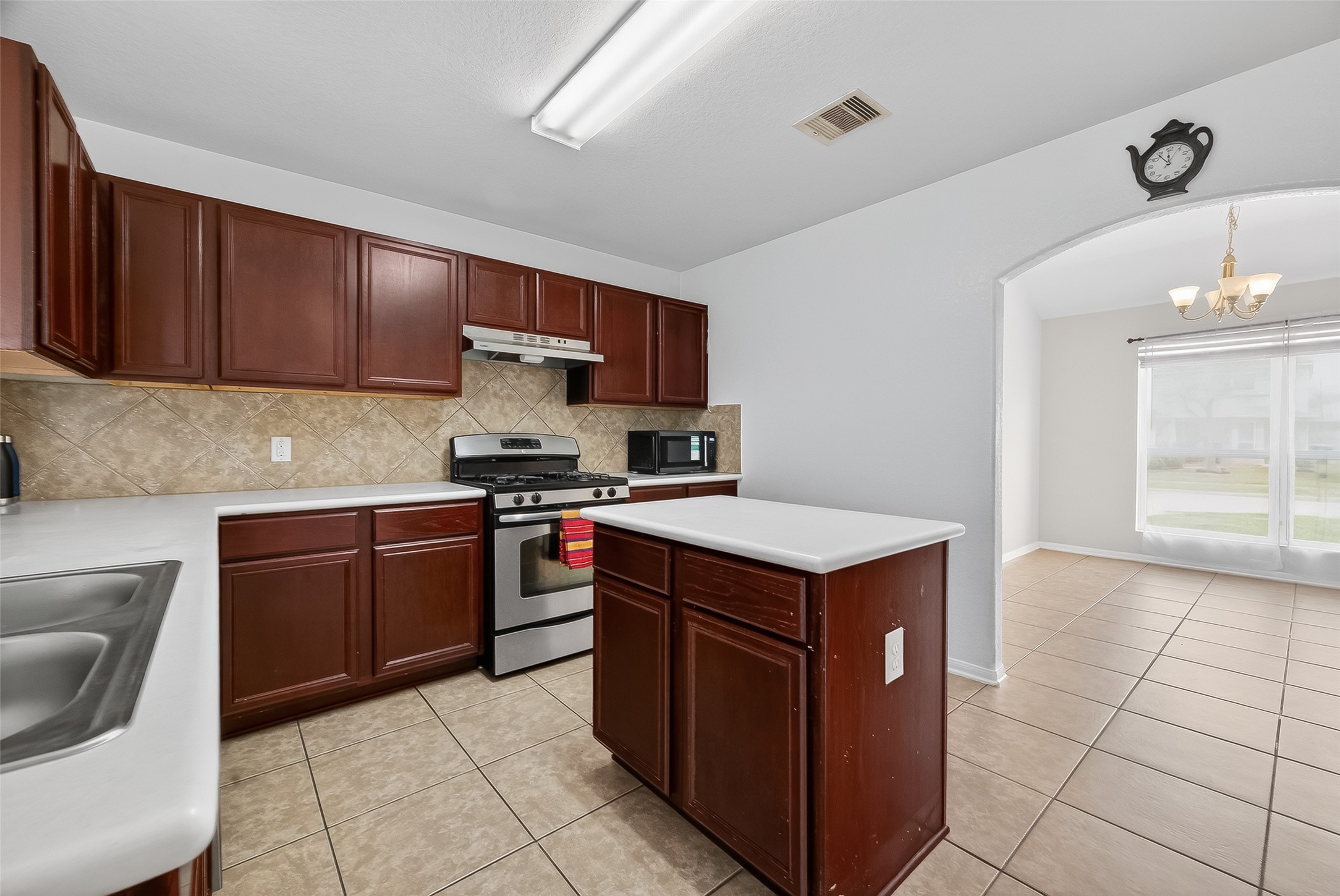 3131 Upland Spring Trace Katy, TX 77493 - Photo 11 of 48 a kitchen with a stove top oven sink and cabinets