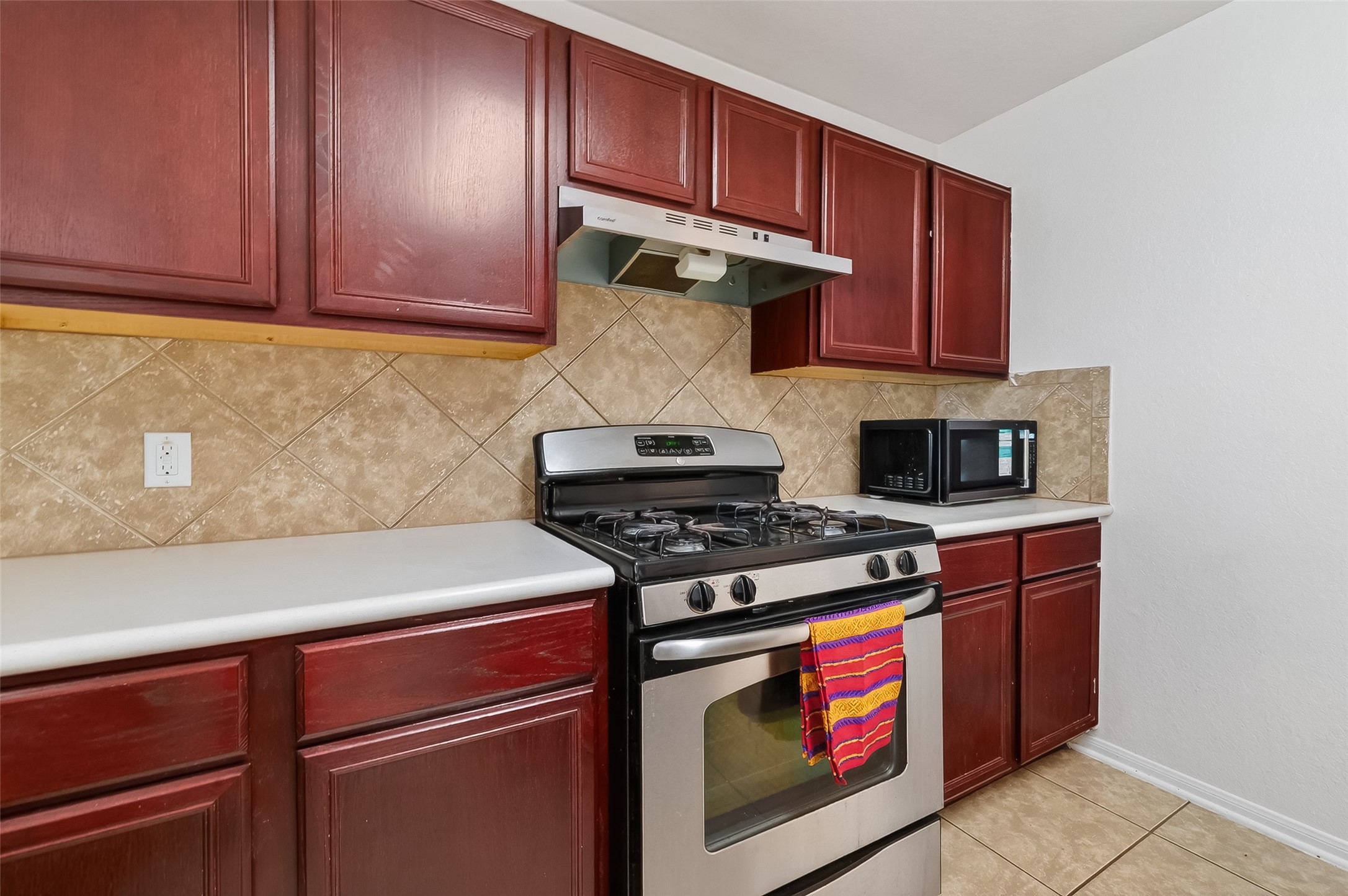 3131 Upland Spring Trace Katy, TX 77493 - Photo 12 of 48 a kitchen with stainless steel appliances granite countertop a stove and a microwave