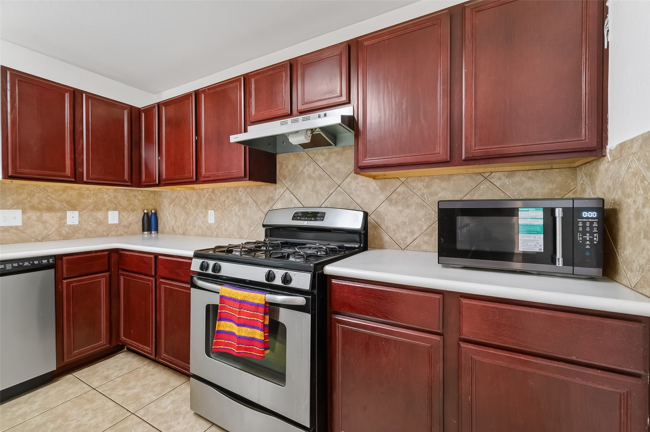 3131 Upland Spring Trace Katy, TX 77493 - Photo 14 of 48 a kitchen with stainless steel appliances granite countertop wooden cabinets stove and a sink