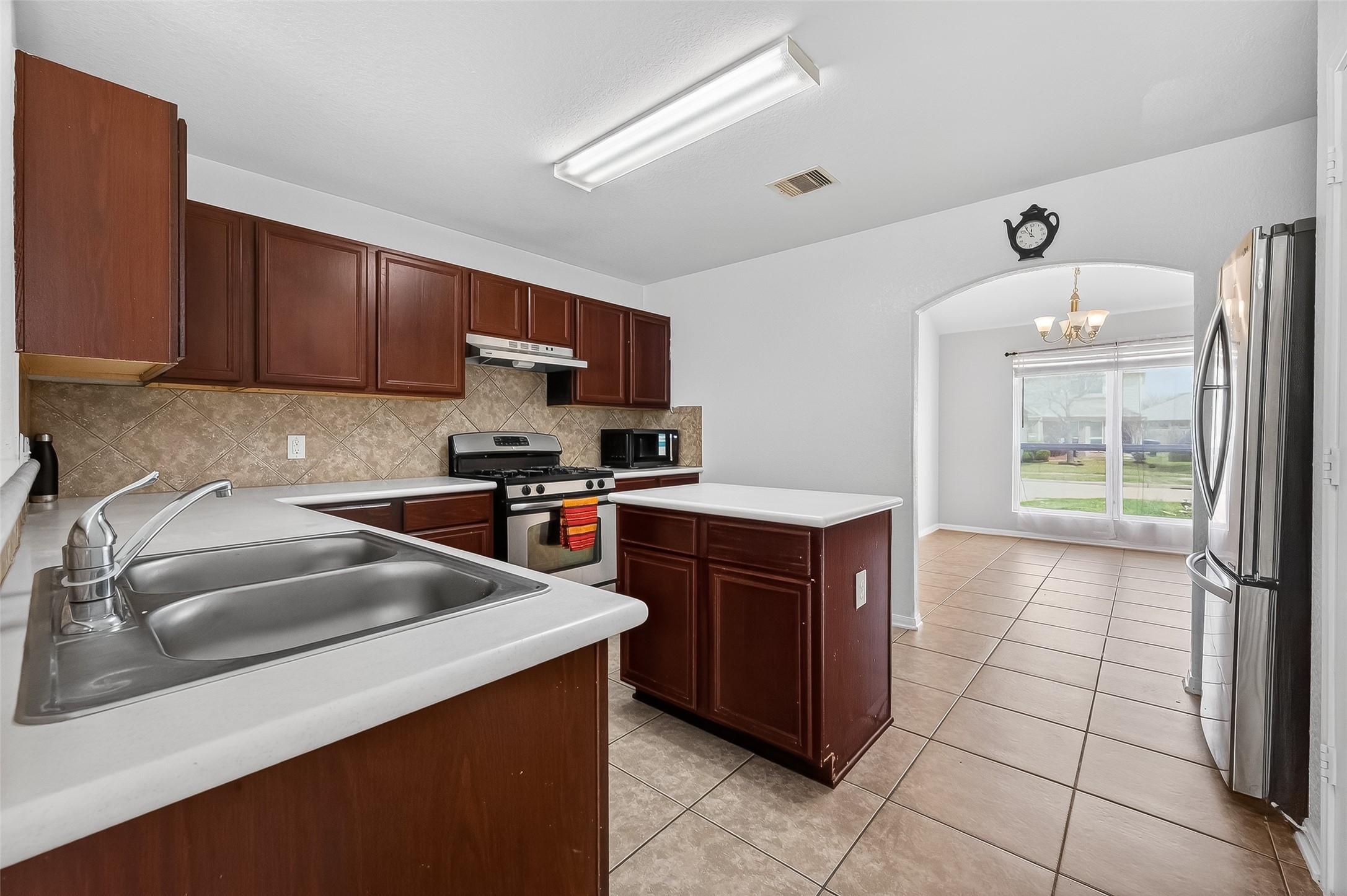 3131 Upland Spring Trace Katy, TX 77493 - Photo 15 of 48 a kitchen with a sink a stove top oven and cabinets