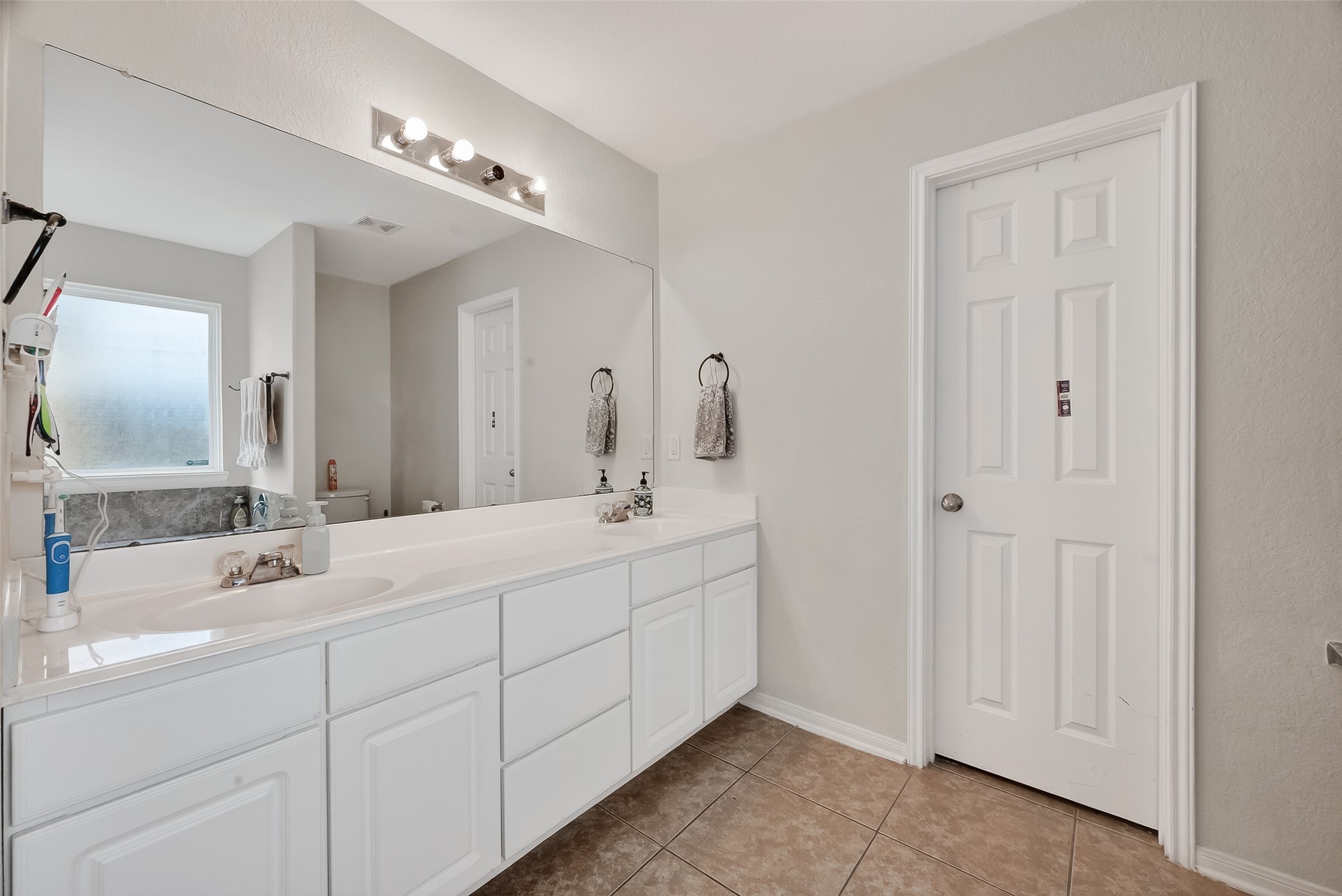 3131 Upland Spring Trace Katy, TX 77493 - Photo 23 of 48 a bathroom with a double vanity sink and mirror