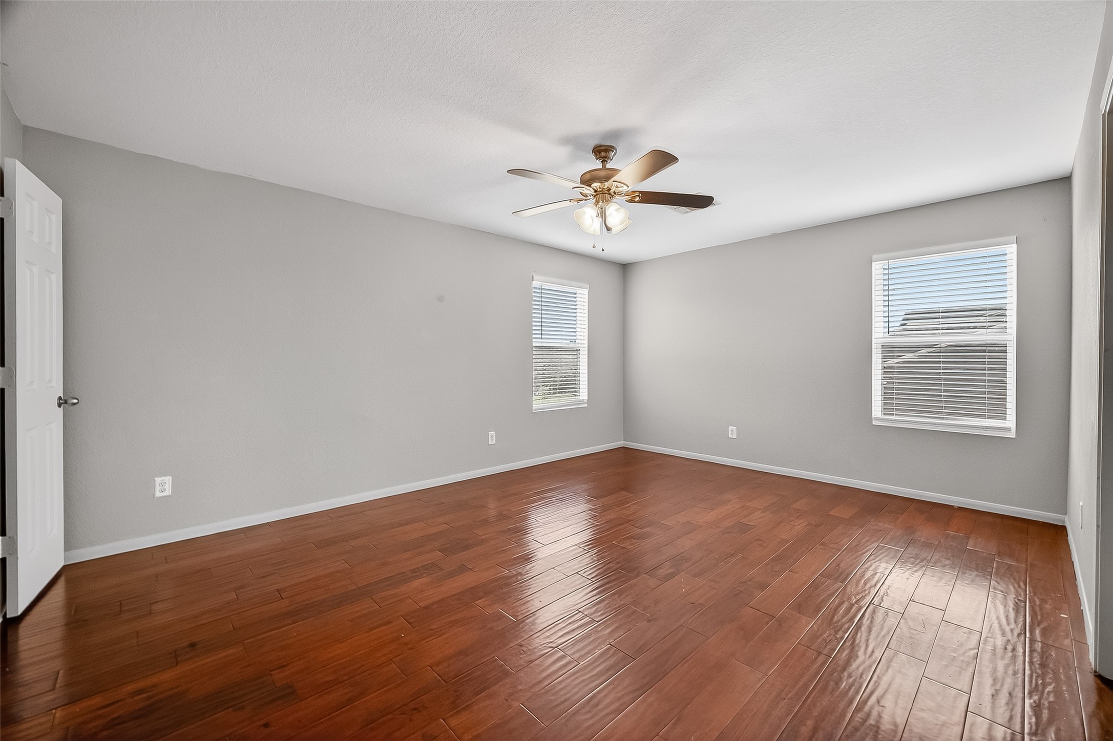 3131 Upland Spring Trace Katy, TX 77493 - Photo 31 of 48 a view of an empty room with a window and wooden floor
