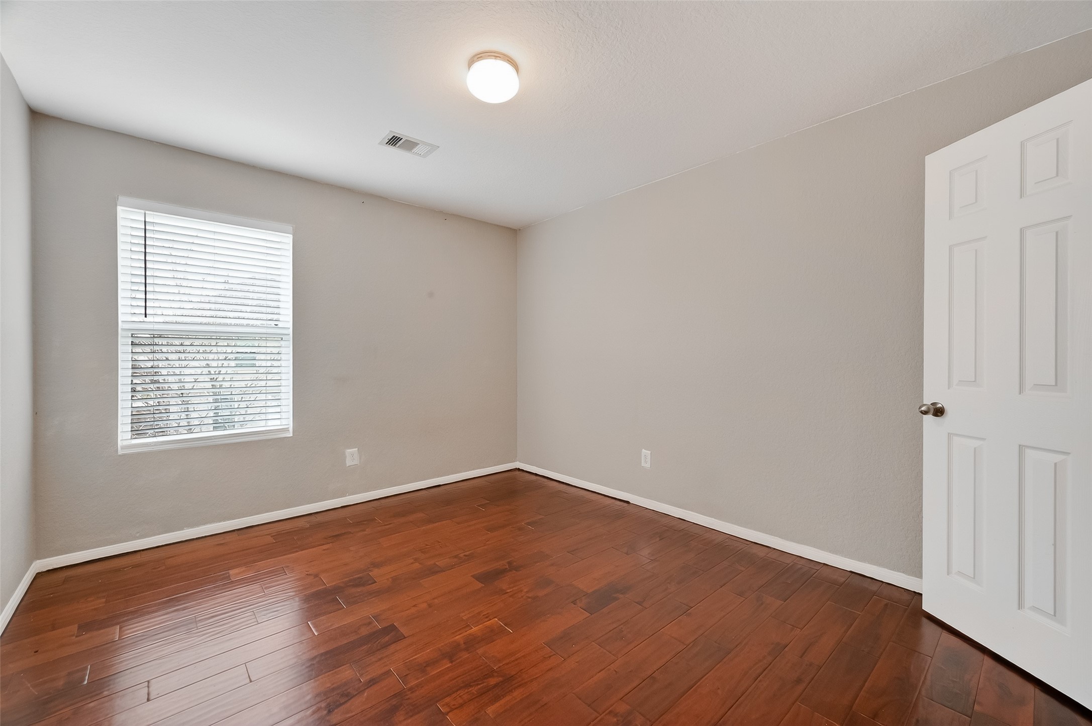3131 Upland Spring Trace Katy, TX 77493 - Photo 38 of 48 an empty room with wooden floor and windows
