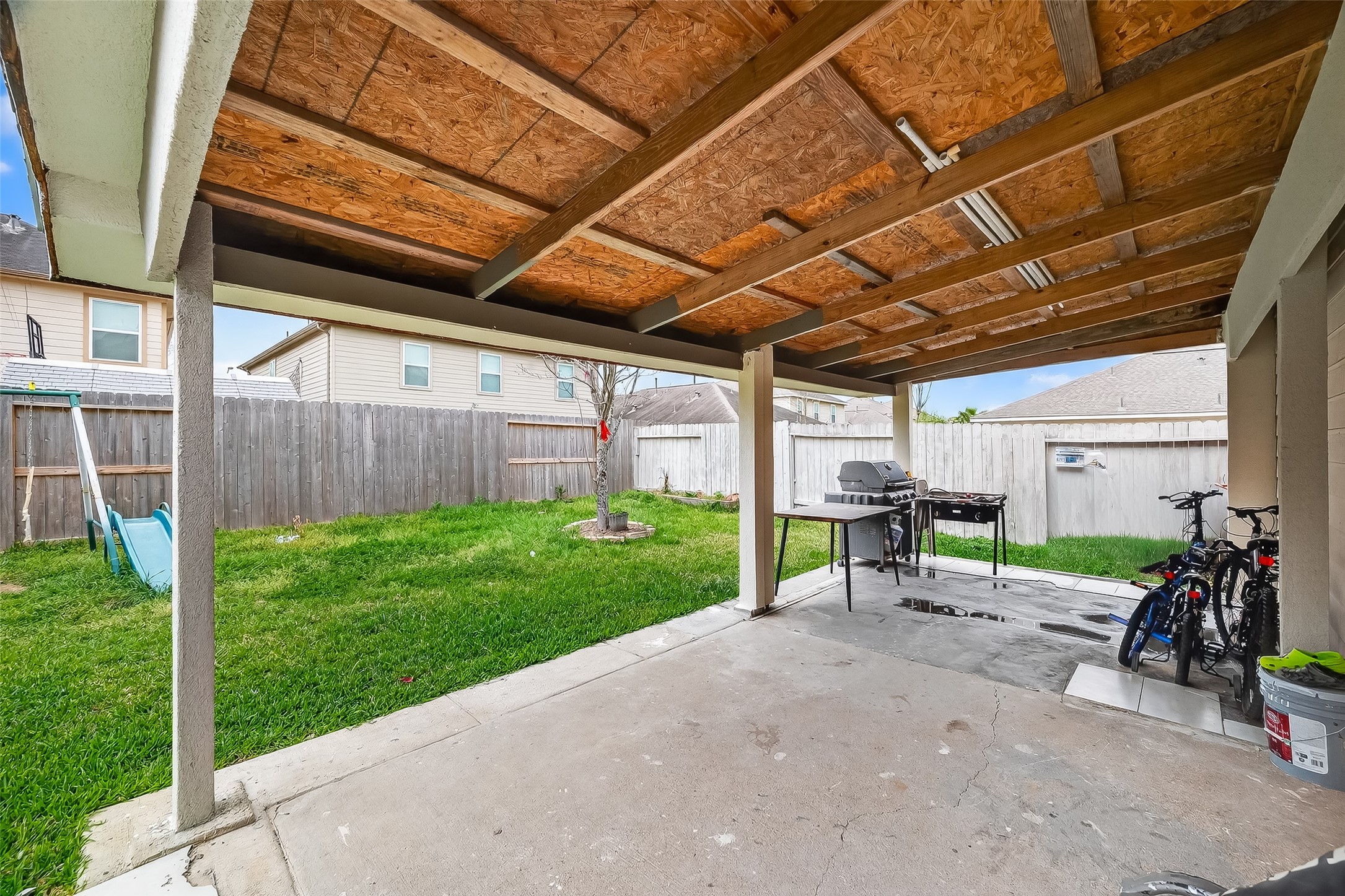 3131 Upland Spring Trace Katy, TX 77493 - Photo 42 of 48 a view of a backyard with table and chairs and a barbeque