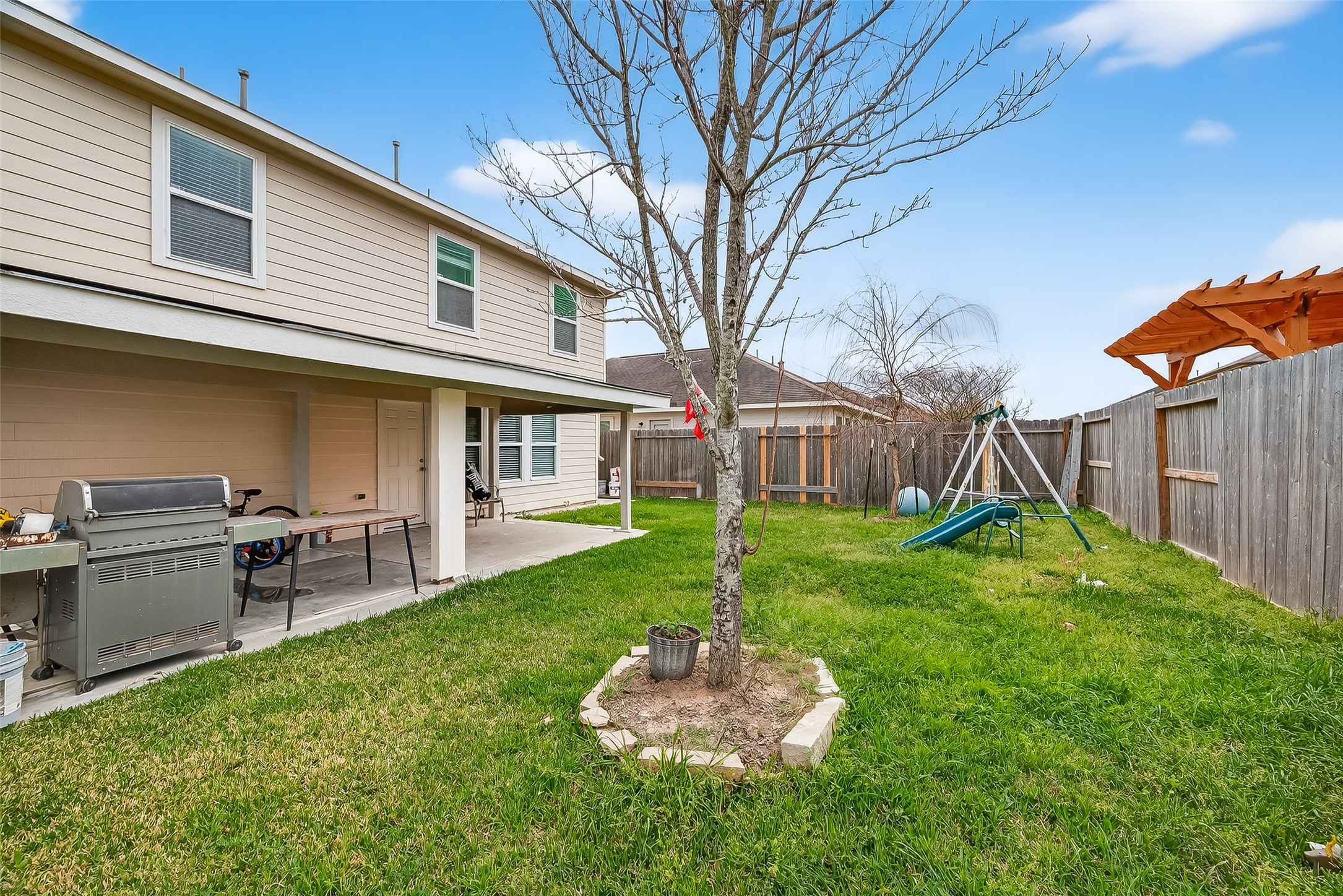 3131 Upland Spring Trace Katy, TX 77493 - Photo 46 of 48 a backyard of a house with table and chairs