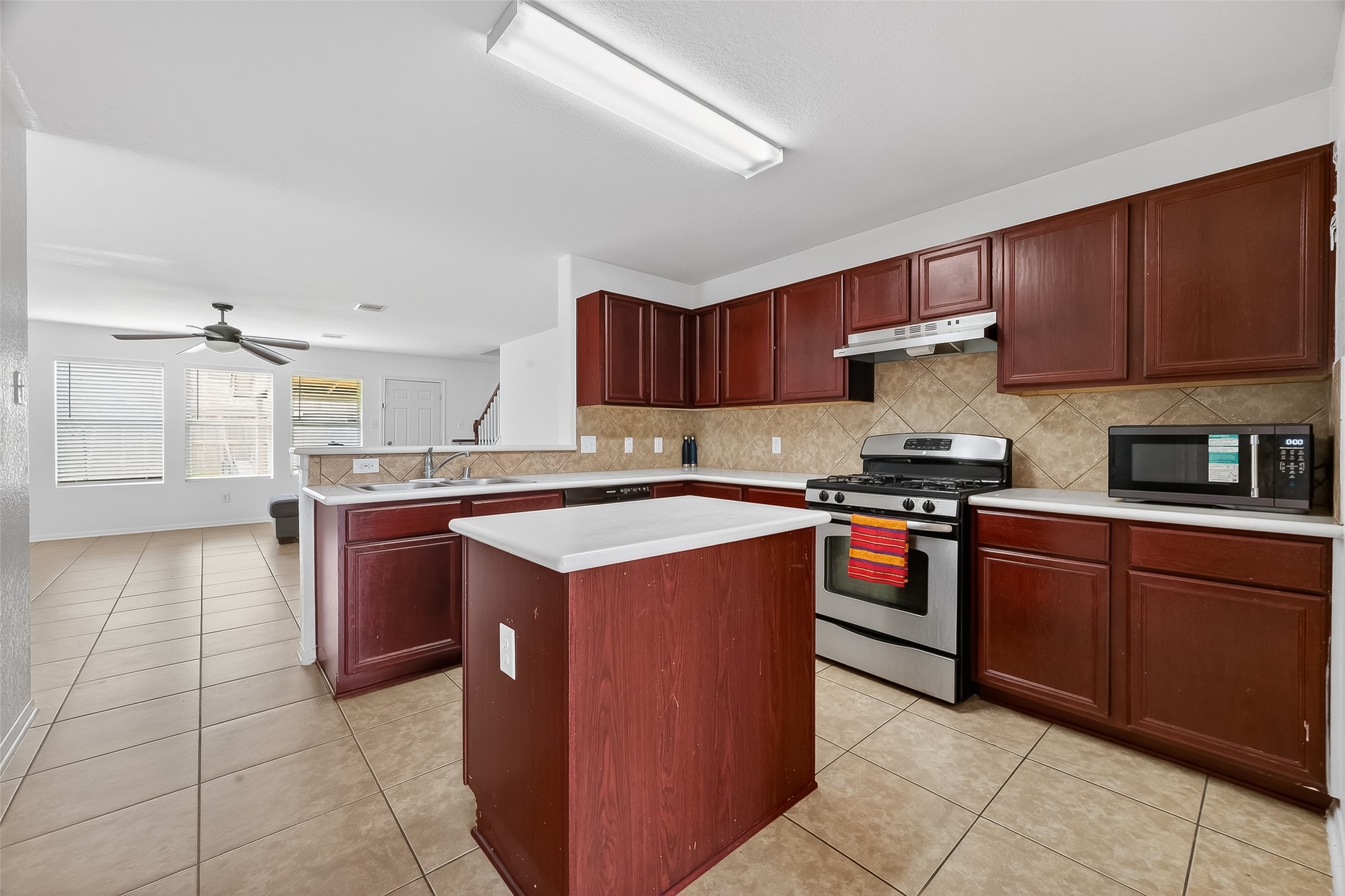 3131 Upland Spring Trace Katy, TX 77493 - Photo 10 of 48 a kitchen with stainless steel appliances granite countertop a stove top oven a sink and a refrigerator