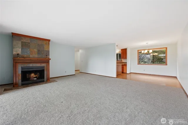 a view of an empty room with a fireplace