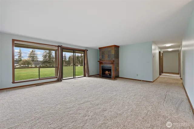a view of an empty room with a fireplace