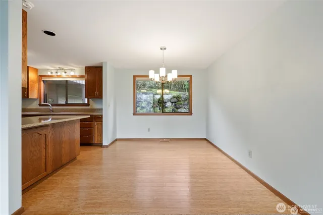 an empty room with windows and fireplace