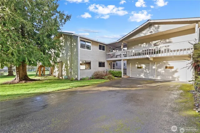 a view of a house with a yard and garage